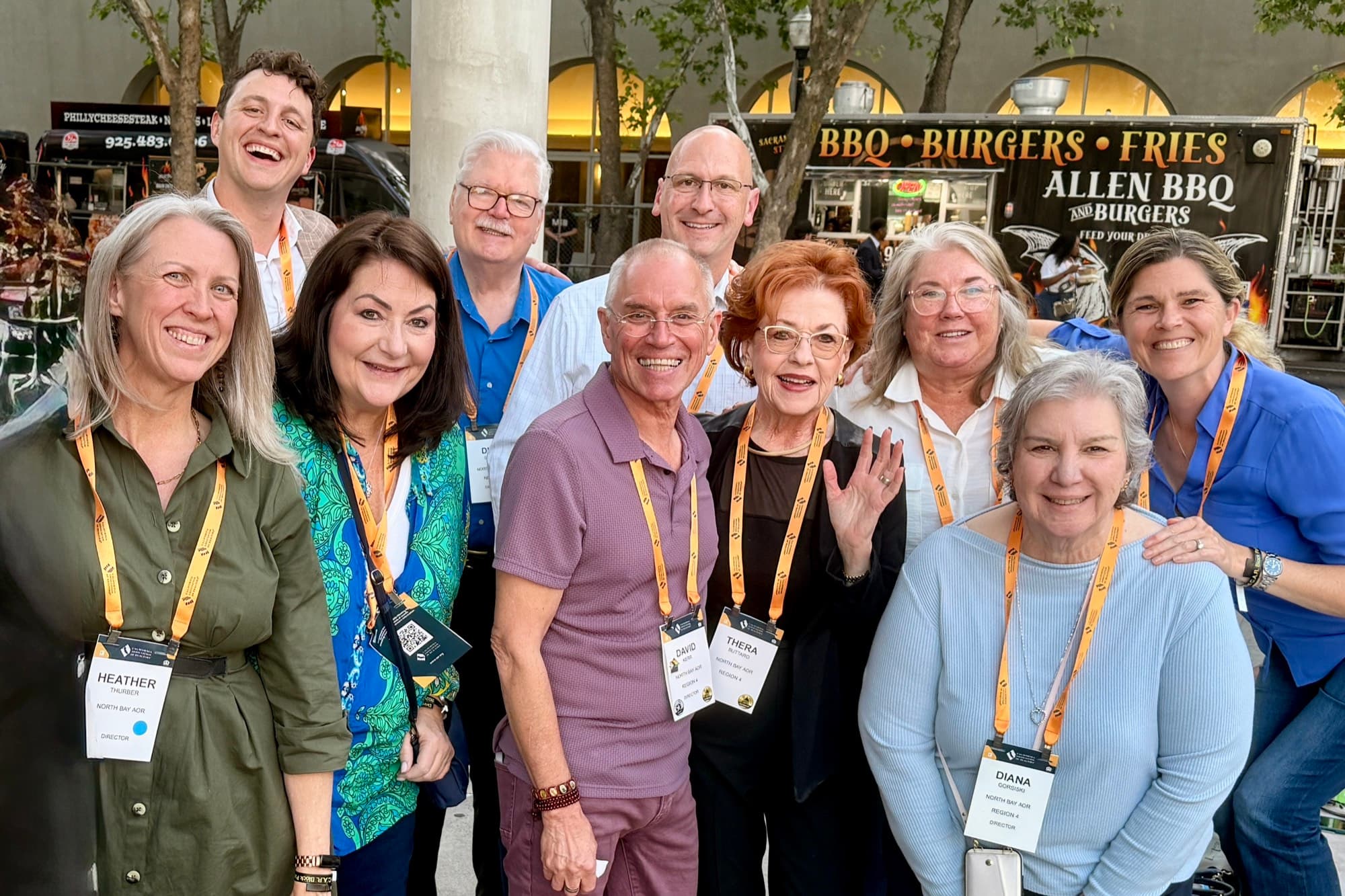 NORBAR directors gathered outdoors at a CAR conference, smiling in their name badges and lanyards