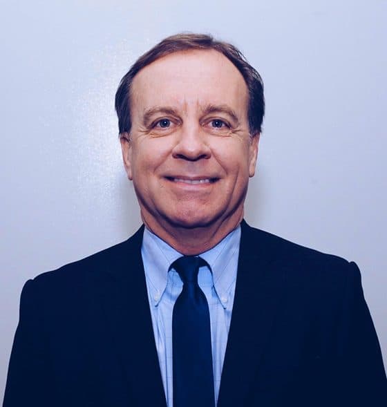 Headshot of Gov Hutchinson, CAR General Counsel, in a navy suit and tie.