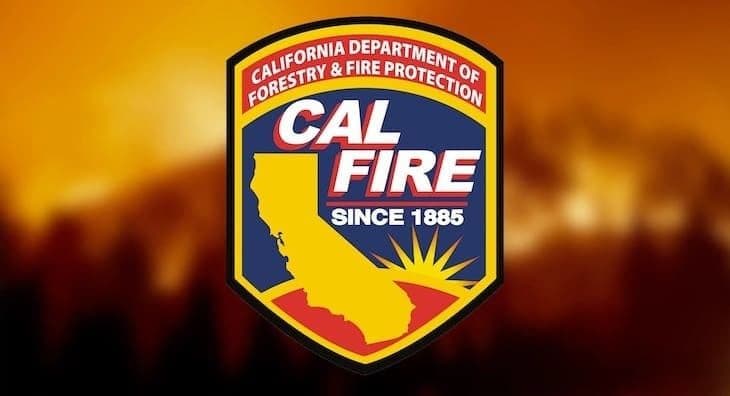 CAL FIRE shield logo on a blurred orange wildfire background.
