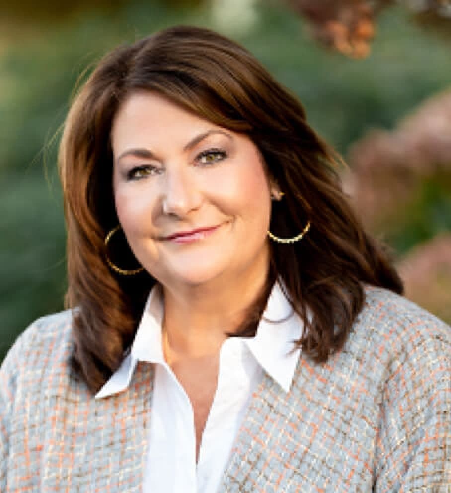 Professional headshot of a smiling woman in a tweed jacket and white shirt, the 2023 NORBAR President who authored this update.